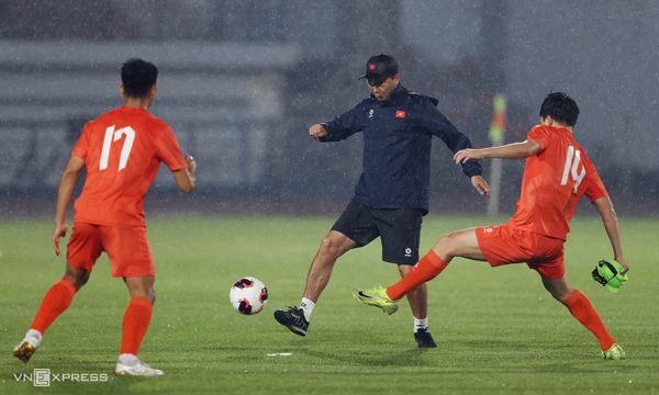HLV Kim Sang-sik tập dưới mưa cùng cầu thủ