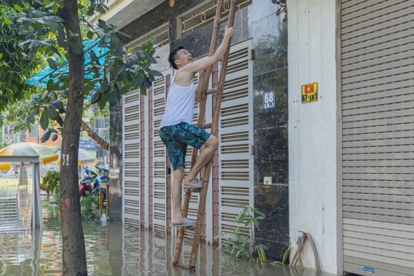Người Hà Nội trèo thang ra khỏi nơi ngập, không điện nước trong biệt thự